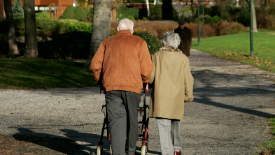 Elderly couple walking along path