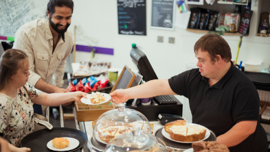 People in cafe with cake